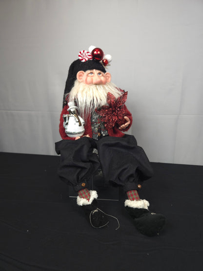 Santa Doll Holding Snowman Ornament and Poinsettia